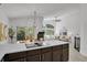 Open-concept kitchen with stainless appliances, breakfast bar, and adjacent dining and living areas at 1894 S Marshall Cir, Lakewood, CO 80232
