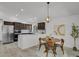 Open kitchen with modern appliances, breakfast bar, and adjacent dining area at 1894 S Marshall Cir, Lakewood, CO 80232