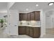 Convenient kitchenette with ample cabinetry, white countertops, and stylish backsplash at 1894 S Marshall Cir, Lakewood, CO 80232