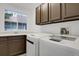 Functional laundry room with washer, dryer, sink, and plenty of cabinet storage at 1894 S Marshall Cir, Lakewood, CO 80232
