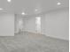 Bright living room with recessed lighting features neutral paint, plush carpeting and multiple doorways at 1894 S Marshall Cir, Lakewood, CO 80232