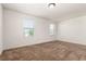 Bedroom featuring two windows and neutral carpet at 19060 E 54Th Pl, Denver, CO 80249