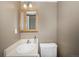 Traditional bathroom featuring vanity with decorative mirror and adjacent toilet at 8901 Field St # 81, Broomfield, CO 80021