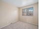 Minimal bedroom with wall-to-wall carpet, neutral paint and natural light from a large window at 8901 Field St # 81, Broomfield, CO 80021