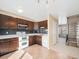 Traditional kitchen featuring tile flooring, granite counters, stainless microwave, and wooden cabinetry at 8901 Field St # 81, Broomfield, CO 80021
