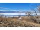 Scenic view of the community lake with a backdrop of snow-capped mountains and clear blue sky at 8901 Field St # 81, Broomfield, CO 80021