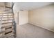 Inviting living area featuring wall-to-wall carpet and an adjacent staircase at 8901 Field St # 81, Broomfield, CO 80021