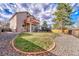 The private backyard has a deck, patio and a manicured lawn with rock bed at 9662 Newcastle Dr, Highlands Ranch, CO 80130