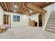 Unfinished basement with carpet, exposed beams, stairs, and a vintage style bar ready for your design at 9662 Newcastle Dr, Highlands Ranch, CO 80130