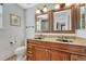 Elegant bathroom with double sinks, granite countertops, and wood cabinets providing style and functionality at 9662 Newcastle Dr, Highlands Ranch, CO 80130