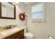 Half bathroom with a mosaic tile backsplash and decorative wreath at 9662 Newcastle Dr, Highlands Ranch, CO 80130