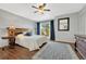 Bedroom with hardwood floors, ceiling fan, sliding door and a large area rug, creating a relaxing space at 9662 Newcastle Dr, Highlands Ranch, CO 80130