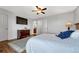 Bedroom with hardwood floors, a TV, dresser, and a large window, creating a relaxing space at 9662 Newcastle Dr, Highlands Ranch, CO 80130