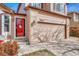 Two-story home features a red front door and attached two-car garage at 9662 Newcastle Dr, Highlands Ranch, CO 80130