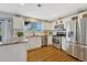 Bright kitchen features stainless steel appliances and granite countertops at 9662 Newcastle Dr, Highlands Ranch, CO 80130