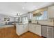 Open-concept kitchen area with white cabinets and stainless steel appliances at 9662 Newcastle Dr, Highlands Ranch, CO 80130