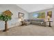 Bright living room features a plush gray sofa and ample natural light at 9662 Newcastle Dr, Highlands Ranch, CO 80130