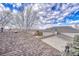 Roof top view showing the house exterior with mature trees with mountain background at 9662 Newcastle Dr, Highlands Ranch, CO 80130