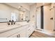 Elegant bathroom with double vanity, quartz countertop, and a frameless shower at 780 Josephine Way, Superior, CO 80027