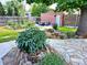 Backyard with stone patio and lush garden at 2895 Dexter St, Denver, CO 80207