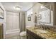 Clean basement bathroom with a granite vanity and tiled shower at 2895 Dexter St, Denver, CO 80207