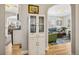 Bright hallway with whitewashed cabinet and views into living room and kitchen at 2895 Dexter St, Denver, CO 80207