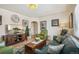 Living room with hardwood floors, comfortable seating, and a large flat-screen TV at 2895 Dexter St, Denver, CO 80207