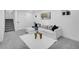 Well-lit basement living room with a plush white sofa, modern decor, and soft carpeting at 1517 S Elkhart St, Aurora, CO 80012