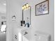 Bright bathroom featuring modern vanity, fixtures, and decor. Tastefully finished with a view to the Primary bedroom at 1517 S Elkhart St, Aurora, CO 80012