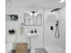 Modern bathroom featuring a sleek walk-in shower, stylish pedestal sink, and contemporary fixtures at 1517 S Elkhart St, Aurora, CO 80012