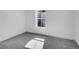 Bright bedroom with gray carpet, a small window and white trim throughout at 1517 S Elkhart St, Aurora, CO 80012