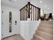 Bright entryway with wooden stairs, white walls and modern fixtures at 1517 S Elkhart St, Aurora, CO 80012