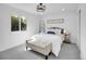 Bright main bedroom with a cozy bed, window view, stylish decor, and soft gray carpeting at 1517 S Elkhart St, Aurora, CO 80012