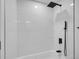 Modern bathroom shower showcasing white subway tiles and matte black fixtures, including a rainfall showerhead at 1517 S Elkhart St, Aurora, CO 80012