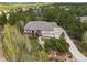 Spacious home surrounded by lush greenery, featuring a long driveway and a deck, creating a serene atmosphere at 20413 Bald Mountain Ct, Monument, CO 80132