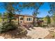 Beautiful backyard featuring a deck, patio, comfortable seating, and mature trees at 20413 Bald Mountain Ct, Monument, CO 80132