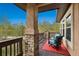 Relaxing outdoor deck with comfortable seating and a scenic view of surrounding trees at 20413 Bald Mountain Ct, Monument, CO 80132