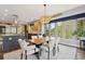 Bright dining area featuring modern lighting, large windows, and views of the landscaped backyard at 20413 Bald Mountain Ct, Monument, CO 80132