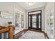 Inviting foyer featuring a decorative front door, hardwood floors, and an elegant staircase at 20413 Bald Mountain Ct, Monument, CO 80132