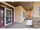 Inviting front porch with stone accents, a unique hanging chair, and a decorative 'Hello' welcome mat at 20413 Bald Mountain Ct, Monument, CO 80132