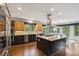 Modern kitchen featuring a large island, stainless steel appliances, custom cabinets and hardwood floors at 20413 Bald Mountain Ct, Monument, CO 80132