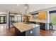 Modern kitchen featuring a large island, stainless steel appliances, custom cabinets and a wine fridge at 20413 Bald Mountain Ct, Monument, CO 80132