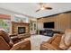 Living room with stone fireplace, wood accent wall, and comfortable leather seating at 20413 Bald Mountain Ct, Monument, CO 80132