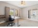 A neutral-toned office features a ceiling fan and french doors with views of the home at 20413 Bald Mountain Ct, Monument, CO 80132