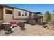 Exterior patio with seating area, stairs to the deck, and lush landscaping at 20413 Bald Mountain Ct, Monument, CO 80132