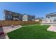 The backyard has a well-maintained lawn, patio, fire pit area, and a wood fence for added privacy at 434 W 128Th Dr, Westminster, CO 80234