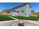 Spacious backyard features a lush green lawn, a patio, and a stone-lined fire pit area for outdoor enjoyment at 434 W 128Th Dr, Westminster, CO 80234