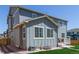 Back of house view showcases neutral siding and trim, a patio, green lawn, and stone landscaping accents at 434 W 128Th Dr, Westminster, CO 80234