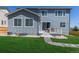 Charming backyard with a well-maintained lawn, a patio, and lovely landscaping with stone walkway at 434 W 128Th Dr, Westminster, CO 80234