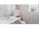 A powder room with a white vanity, a gray cabinet, and a decorative mirror at 434 W 128Th Dr, Westminster, CO 80234